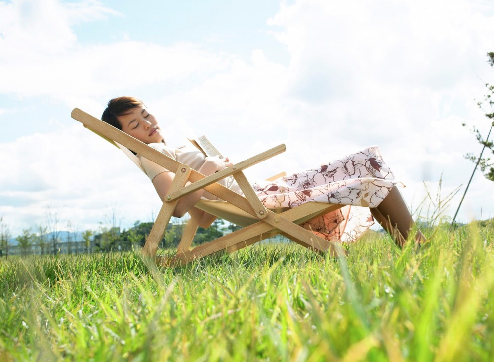 Young Woman Sleeping on Lawn Chair